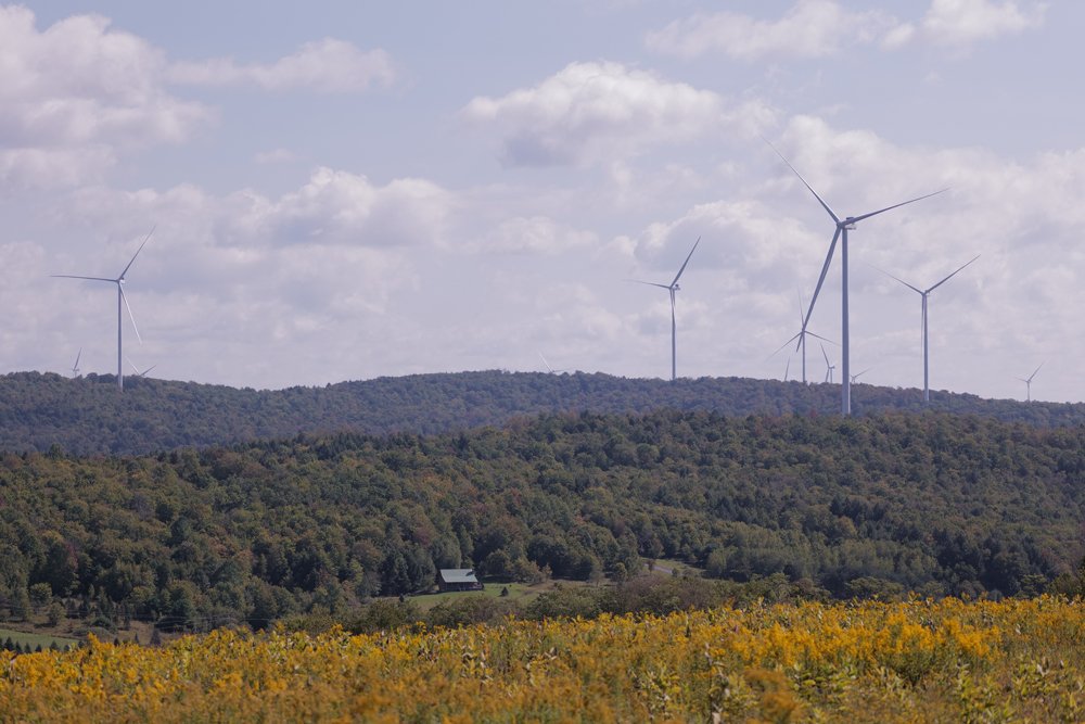 a picture of Wind mills in the fair with hills